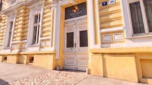 A building with a classical architectural style, featuring ornate window frames and decorative moldings. - TurnKey | Angelo Roma Studio VI (Praha 2)