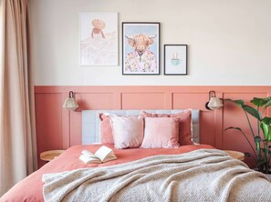 A bedroom with a bed, pillows, a blanket, and wall art. - TurnKey | Letna Park Apartment I – Premium Terrace (Praha 7)