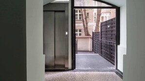 A narrow corridor with a door leading to a balcony.