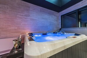 Unwind in a serene spa area with a large hot tub and comfortable seating.