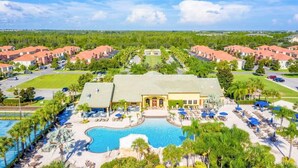 A resort with a central building, a swimming pool, and multiple villas. - Resort Townhome with Pool · Game Room & Sauna (Kissimmee)