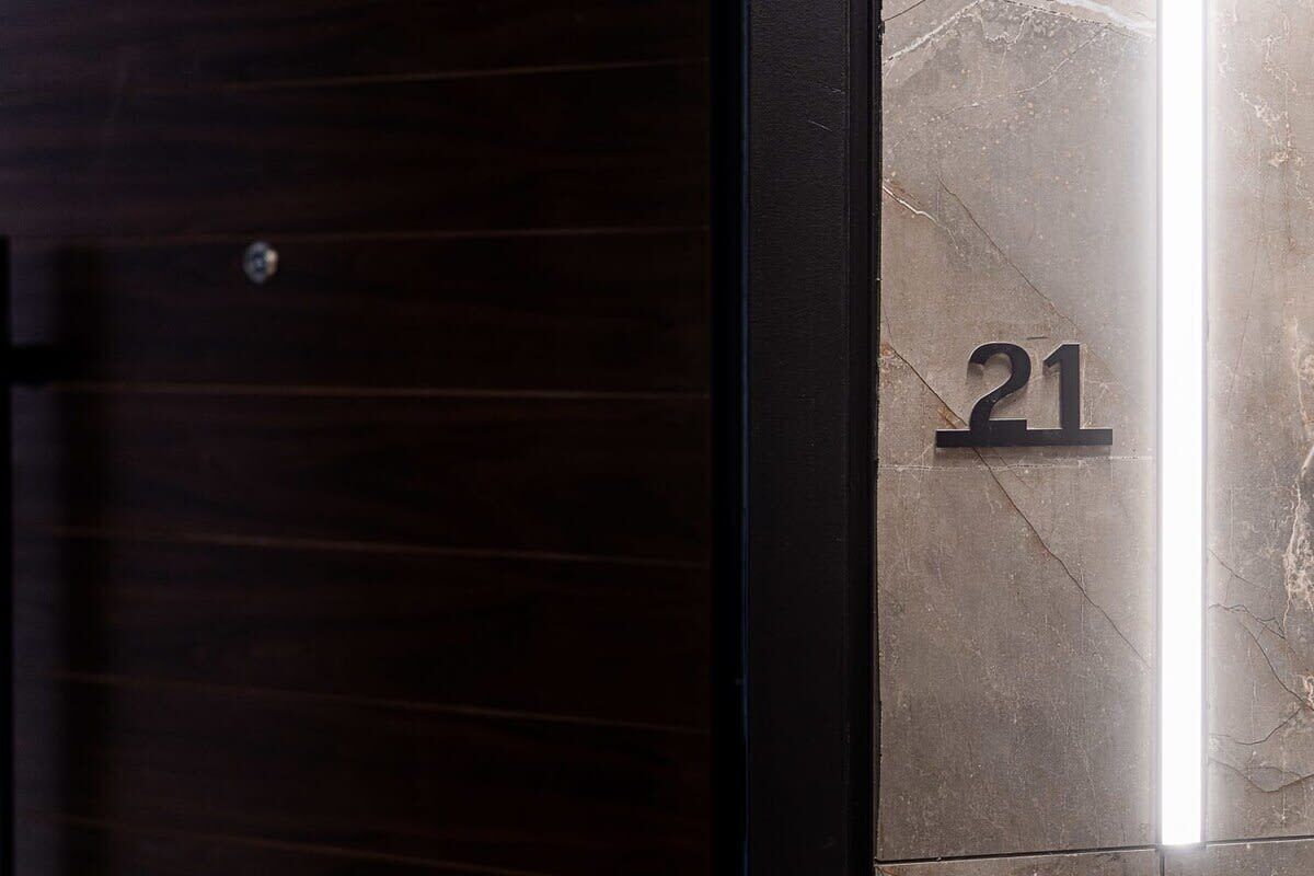 A close-up of a marble wall with the number '21' engraved on it.