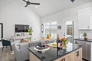 Enjoy cooking and socializing in this well-equipped kitchen with a central island, oven, and dishwasher.