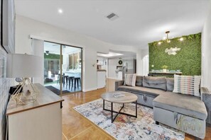 Relax in this stylish living room with a sofa, coffee table, and balcony access.