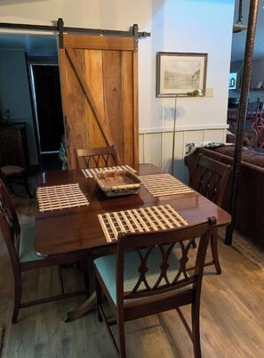 Cozy dining area with a wooden table and matching chairs, perfect for family meals.