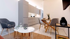 Un salon moderne avec un coin repas, une cuisine en arrière-plan et un panneau indiquant « BISTROT » posé sur une table.