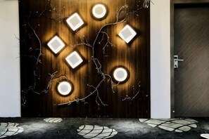 A wooden door with recessed lighting and a geometric pattern. - Xiaomi Hotel (Guangzhou)