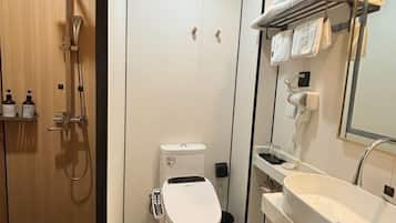 A modern bathroom with a shower, toilet, and sink.