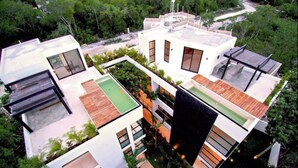A modern multi-story building with rooftop terraces, large windows, and a swimming pool. - Royal PH Private Rooftop Deck Pool (Tulum)