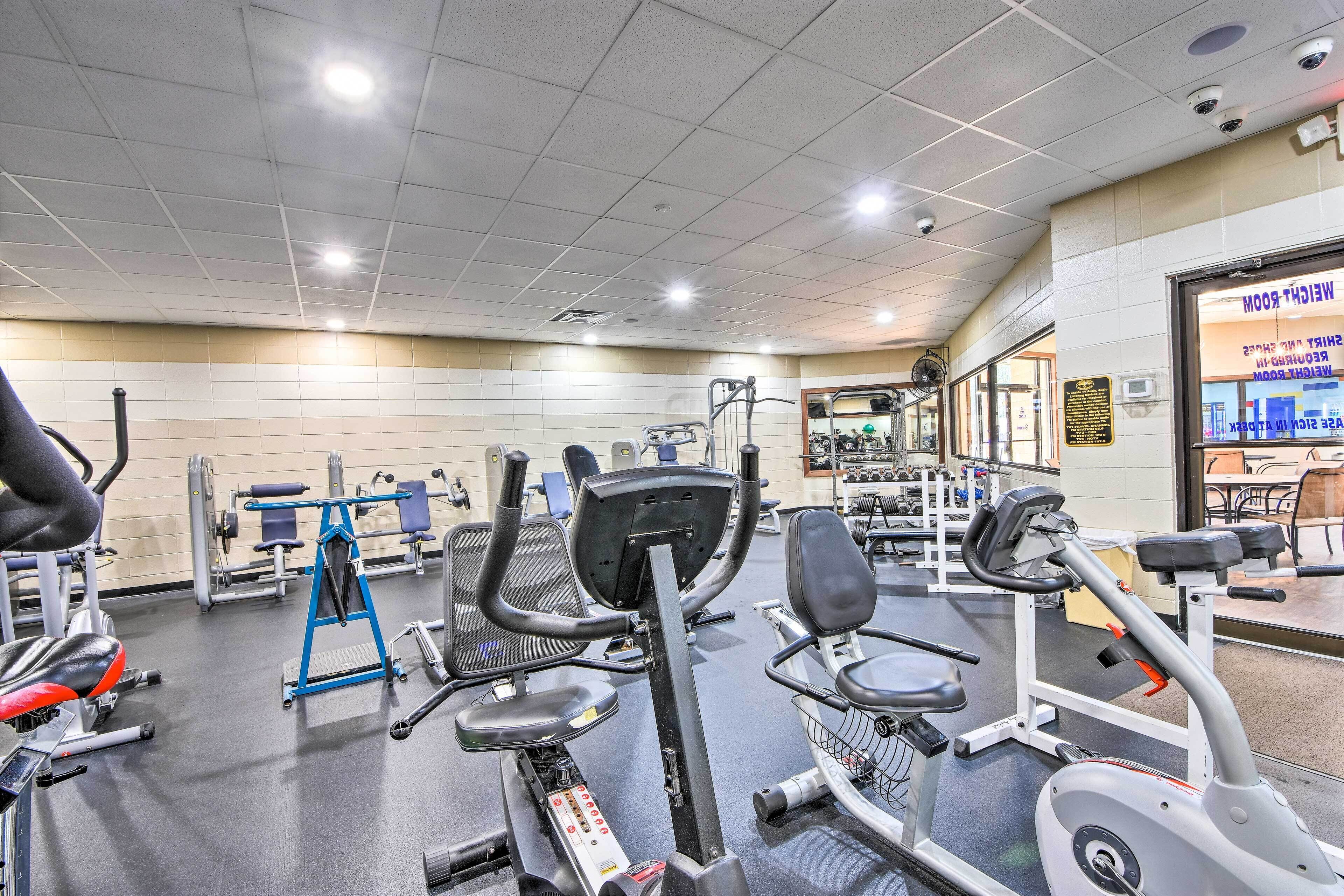 A gym with various exercise equipment, including treadmills and weight machines.