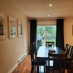 Enjoy meals in this dining area with a table for four and a view of the lush outdoor space.
