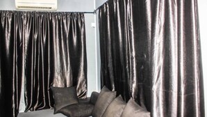 A room with a sofa and curtains. - Smilley's Place Cosy accommodation close to Unilag (Lagos)