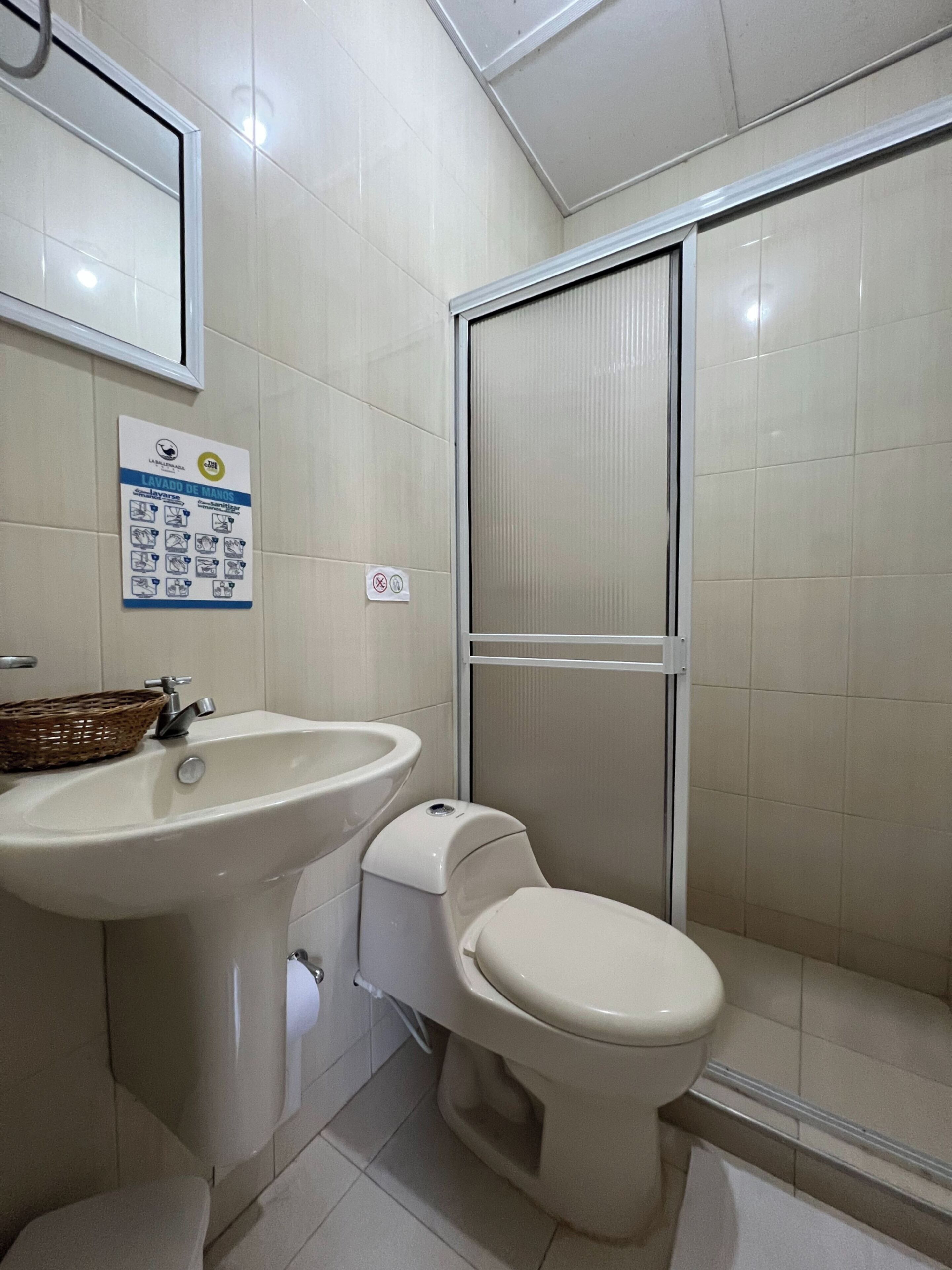 A bathroom with a sink, toilet, and shower.
