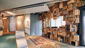 A cozy interior with wooden crates as shelves, a staircase, and a patterned rug. - Villa Viva Hotel Hamburg (Hamburg)
