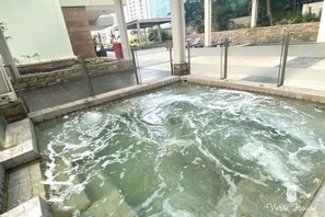Relax in a hot tub with a serene view of the surroundings.