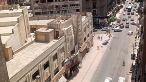 A multi-story building with a flat facade, numerous windows, and air conditioning units. - New Panorama Palace (Cairo)