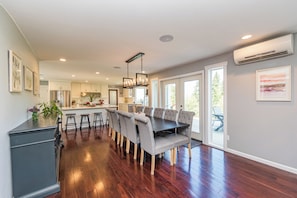 A spacious kitchen with a dining area, wooden flooring, and a view of the outdoors. - Private Home In the woods! (Sequim)