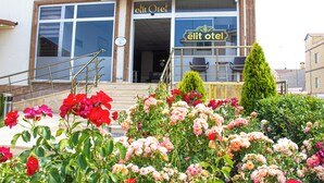 Un edificio con un cartel que dice "elit otel" y una escalera que lleva a la entrada.