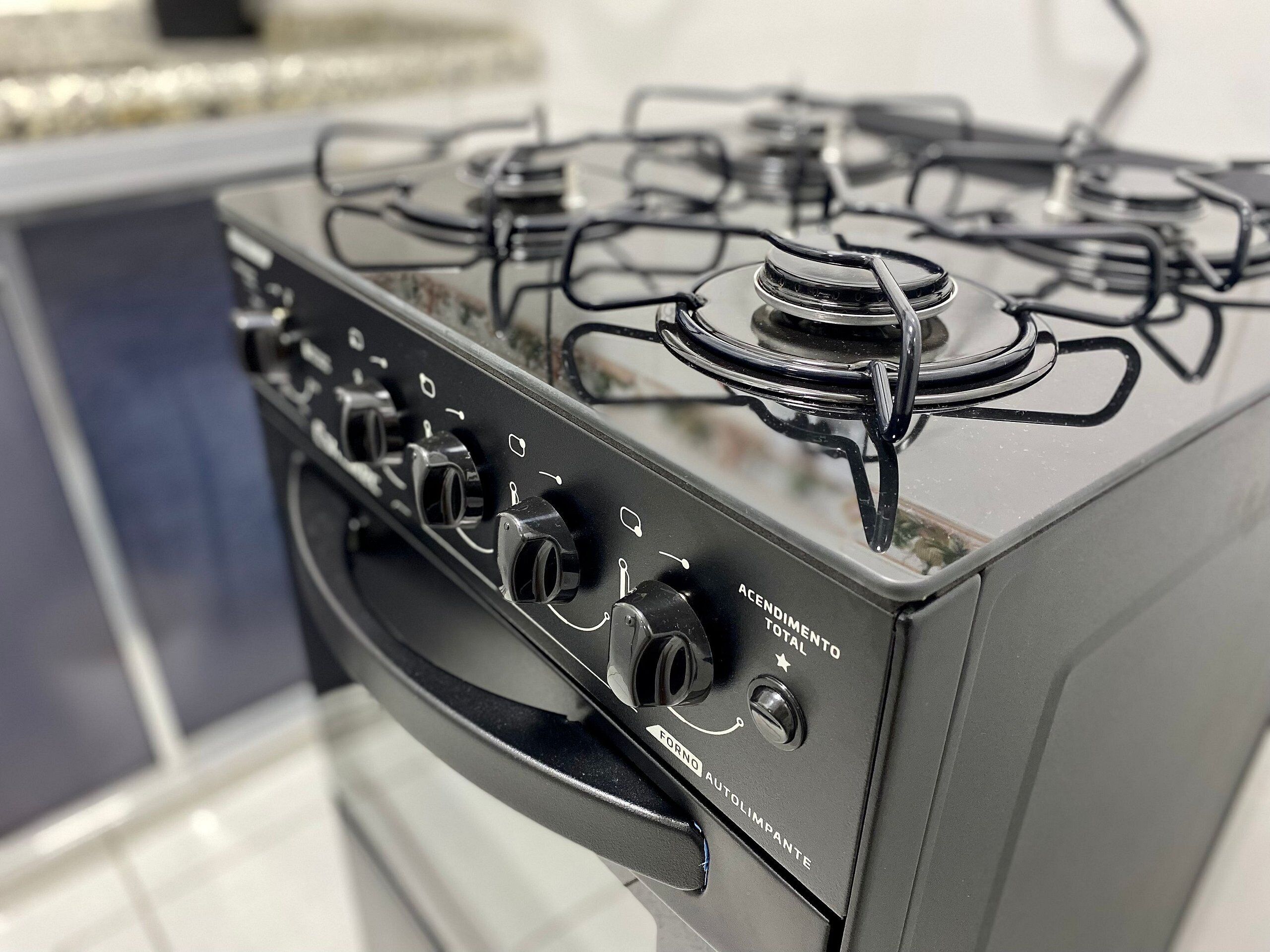 A kitchen with a stove, oven, and a range hood.