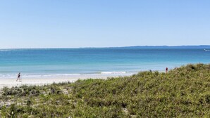 A beach with clear skies and calm waters. - Modern Beachside Escape (WOORIM)
