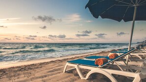 A beach with lounge chairs and an umbrella, facing the ocean. - BEAUTIFUL Resort Located Directly On The Sand! - City View Room  (Fort Lauderdale)