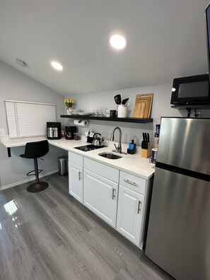 Fridge, microwave, stovetop, coffee/tea maker