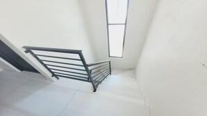 A staircase with a metal handrail and a window at the top. - Casamar 4 by Kivoya (Puerto Peñasco)