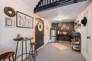 Enjoy cooking and dining in this well-equipped kitchen with a refrigerator, microwave, and sink.