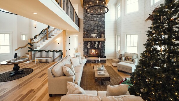 A spacious living room with a fireplace, a staircase, and a Christmas tree. - 🐎 Ann Riley Farmhouse | In Yuba Vineyards | Near GLEF | Trailer & Pet-Friendly | Game Room➠8062 (Williamsburg)