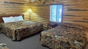 A log cabin room with two beds, a lamp, and a window. - Bear Lodge Resort (Dayton)