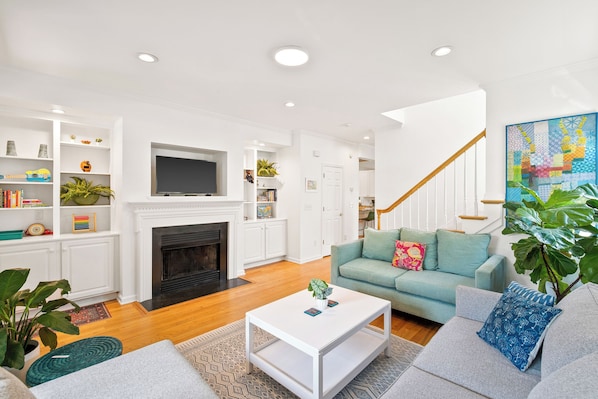 Cozy living space with a fireplace, flat-screen TV, and comfortable seating area.