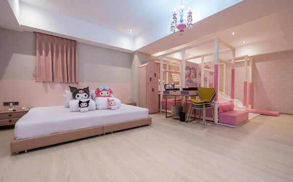 A modern bedroom with a large bed, a desk, and a play area with a slide. - JANGYU ALMOND KIDS HOTEL (Gimhae)