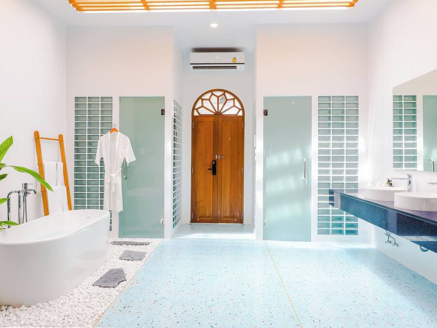 A modern bathroom with a freestanding bathtub, a large mirror, and a glass shower enclosure.