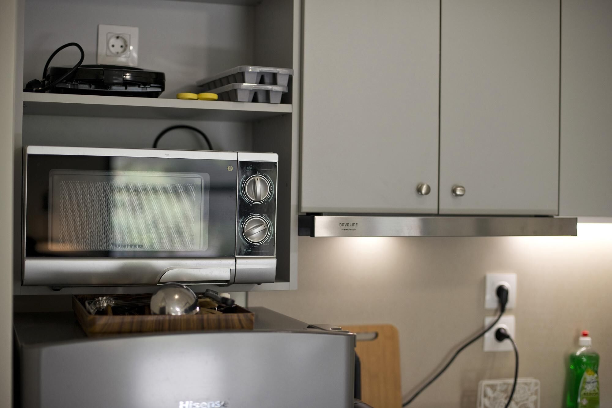 A kitchen with a microwave, a stove, and cabinets.