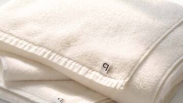 A folded white towel with a tag.