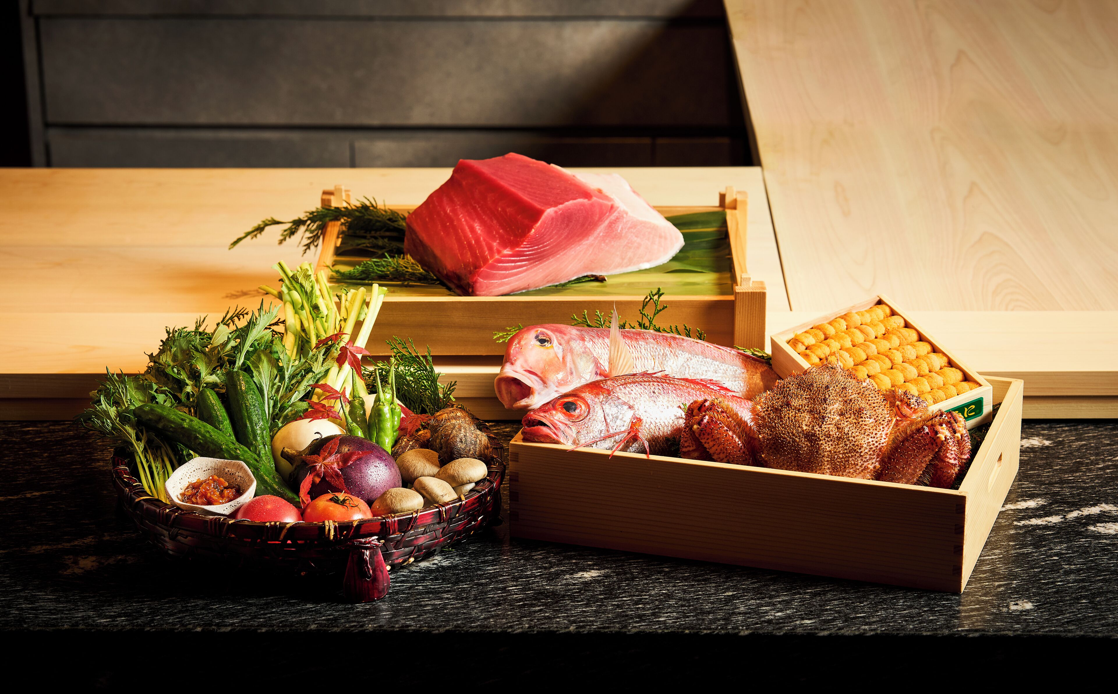 A variety of fresh seafood and vegetables on a wooden table.