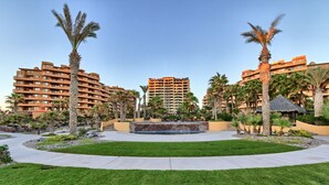 A resort with multiple-story buildings, a central water feature, and well-maintained lawns.