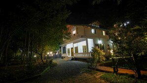 A two-story building with a covered porch and a paved entrance. - B'camp Resorts & Homestays (Vythiri)
