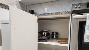 A kitchen with a built-in oven, stainless steel appliances, and a countertop with a coffee maker. - Family-friendly, clean & affordable 2-BR basement suite close to YEG airport. (Edmonton)