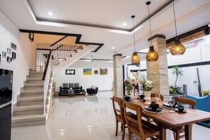 Enjoy meals in the dining area with a table set for two, surrounded by artwork and natural light.