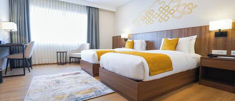A hotel room with two beds, a desk, a chair, and a large window with curtains.