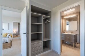 Ein modernes Schlafzimmer mit großem Kleiderschrank, Nachttisch und Nachtkonsolen.