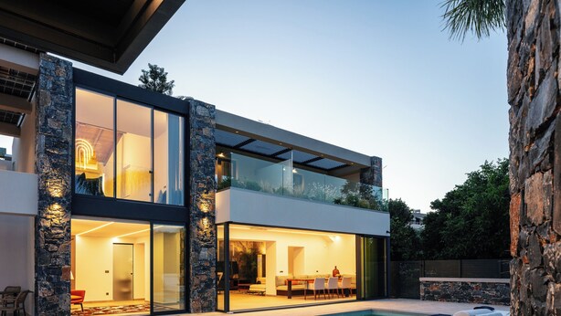 A modern two-story house with a glass facade, a swimming pool, and outdoor seating. - Casa del Balo - Harmony in Nature by etouri (Chania)