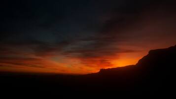 A sunset over a mountainous landscape.