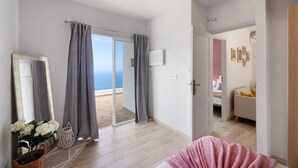 A bedroom with a large window, a bed, a dresser, and a view of the sea. - Holiday Home 'Valista' with Sea View, Private Pool and Wi-Fi (Tijarafe)