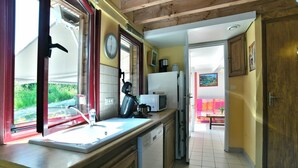 A kitchen with a sink, microwave, and refrigerator.