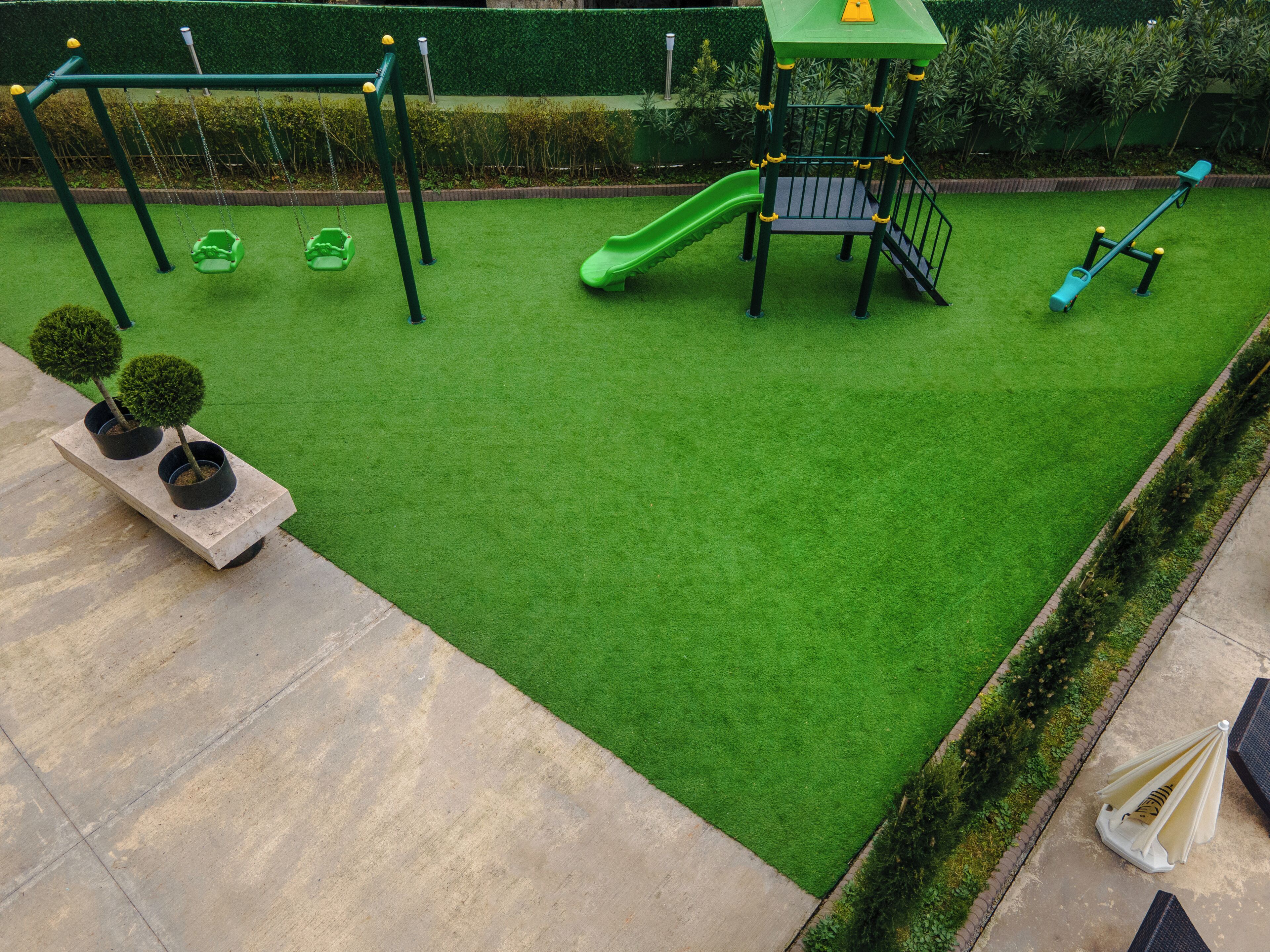 A playground with a slide, swings, and climbing structures.