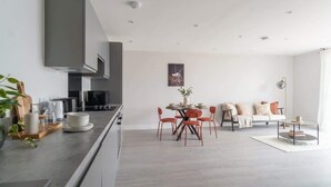 Une cuisine moderne avec un coin repas, un canapé et une table basse.