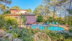 A house with a swimming pool surrounded by lush vegetation and a patio area with lounge chairs. - Beautiful home in Les Arcs (Les Arcs)
