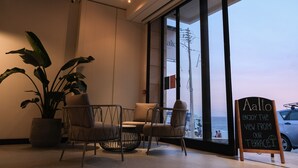 Um interior moderno com vista para um terraço, área de estar e um quadro negro.